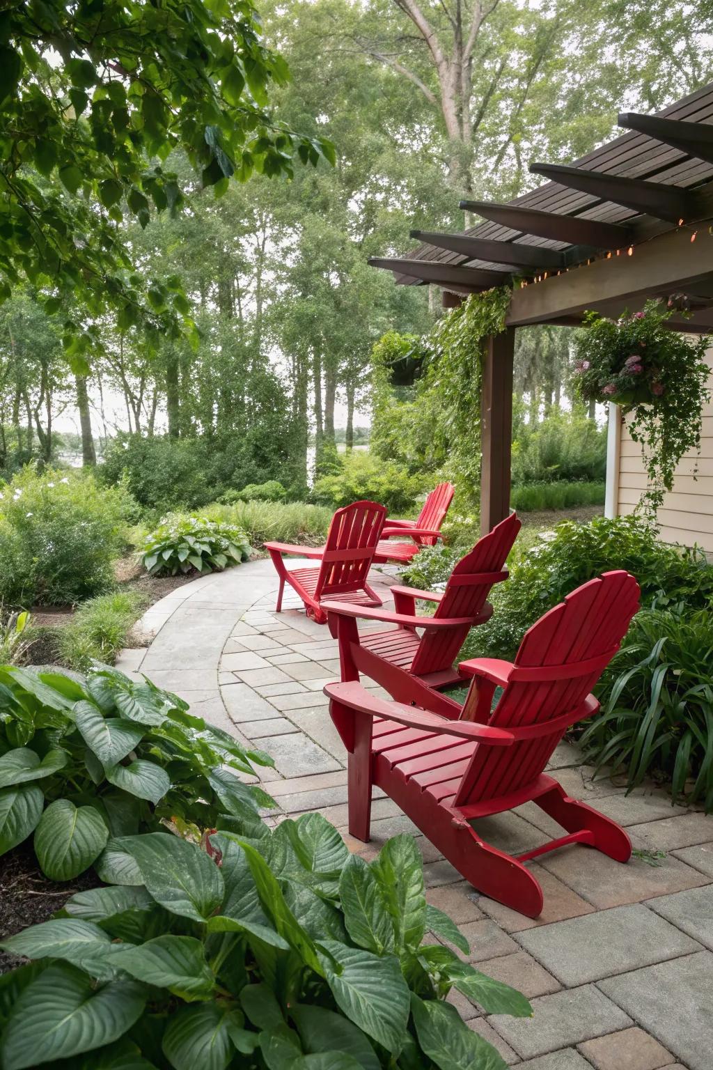 Red Adirondack chairs create a striking contrast against lush greenery.