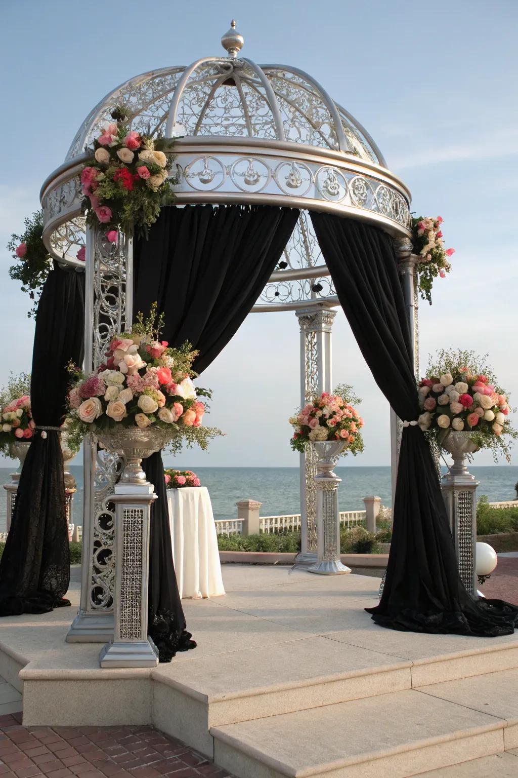 A unique ceremony arch with black and silver elements.