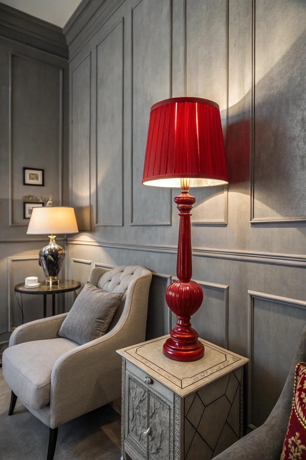 A red lamp adds flair to a grey-toned room.