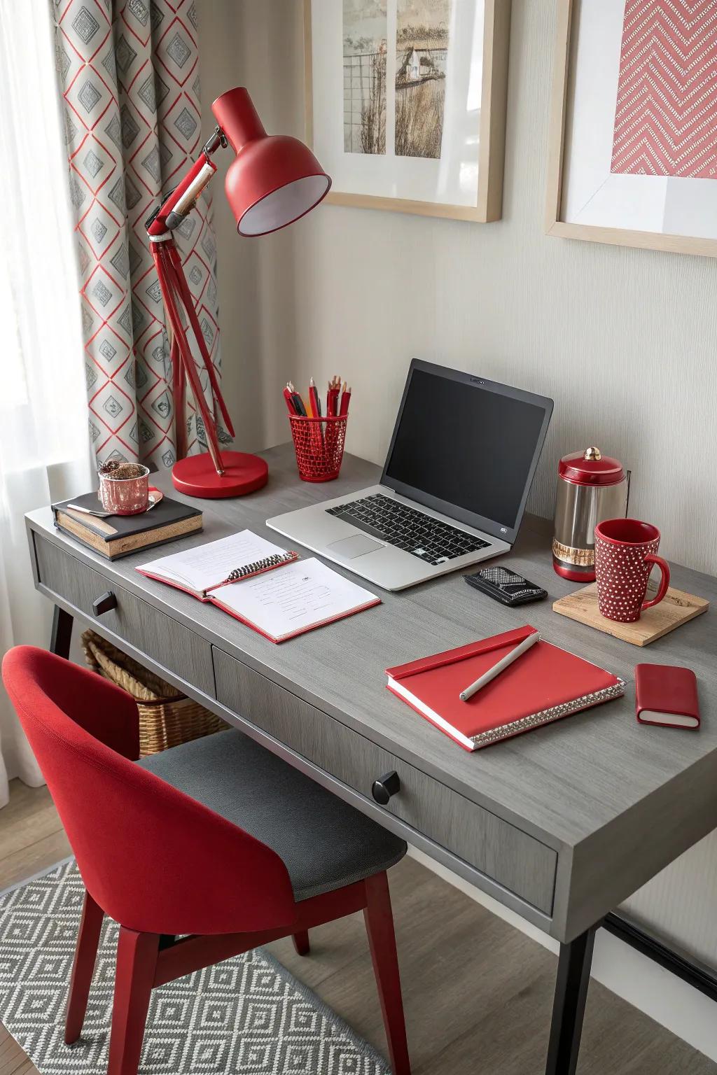 A home office featuring a grey desk and vibrant red accessories.