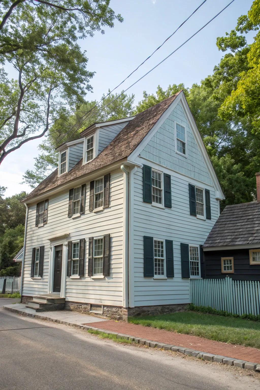 A colonial home displaying a fashionable dual-tone façade with planking and cladding.